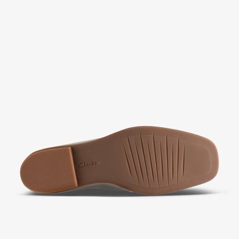Shoe sole with a rubber heel and grooves.