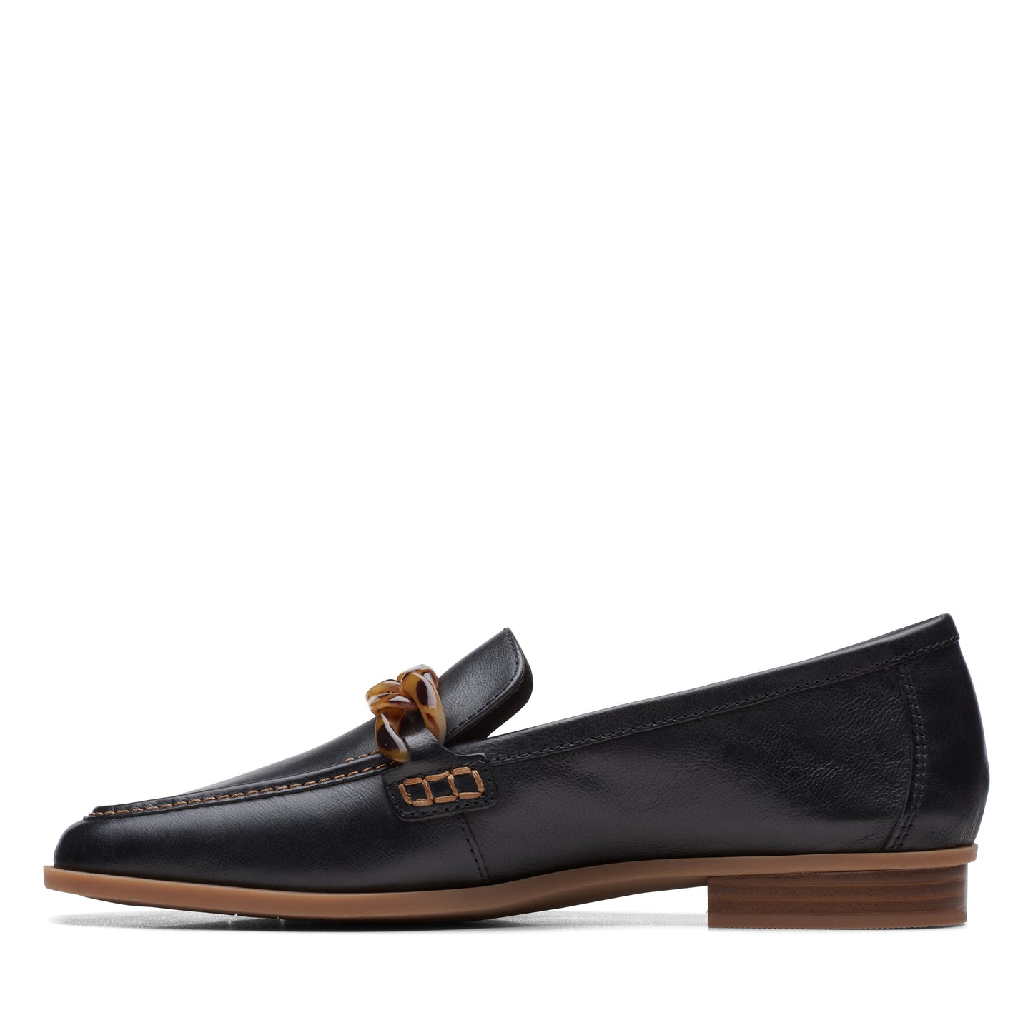 Black leather loafer with a brown chain embellishment.