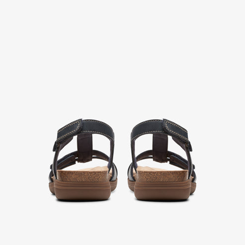 Rear view of sandals with black straps and brown soles.