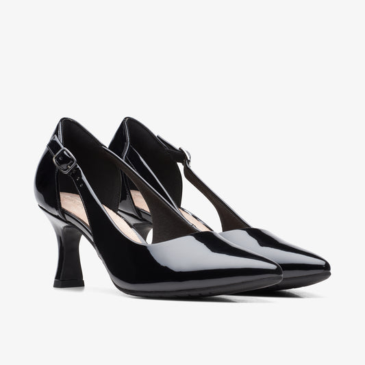 Pair of glossy black leather heels with ankle straps.