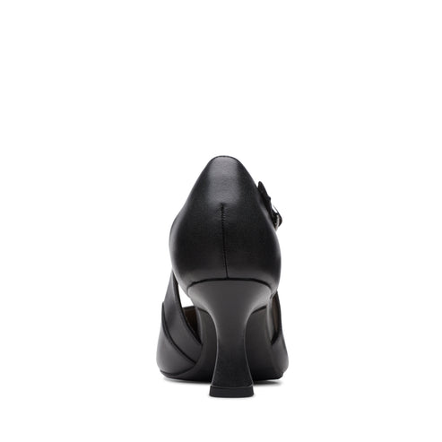 Black leather high heel dress shoe with a closed toe and an ankle strap, rear view.