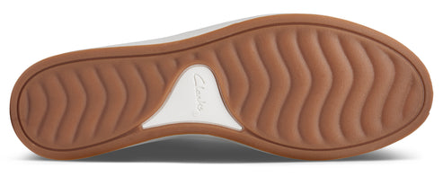 The sole of a shoe with a textured brown rubber pattern and a white logo area.