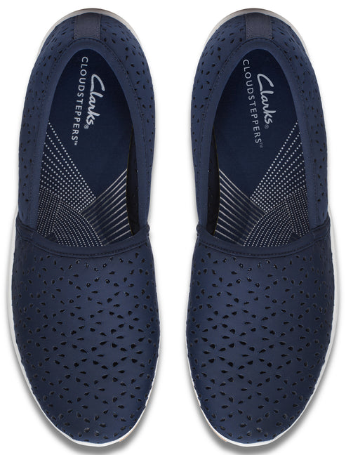 A pair of navy blue, perforated slip-on shoes with white soles, as seen from above.