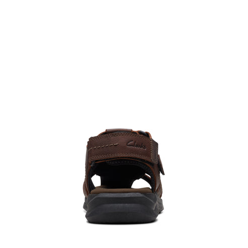 Rear view of an open-toed brown leather sandal with thick black sole.