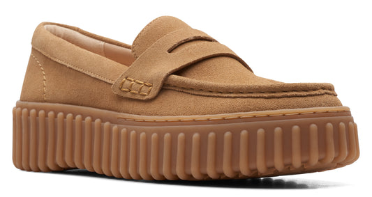 Loafer style shoe in a tan color, featuring a thick, ridged sole.