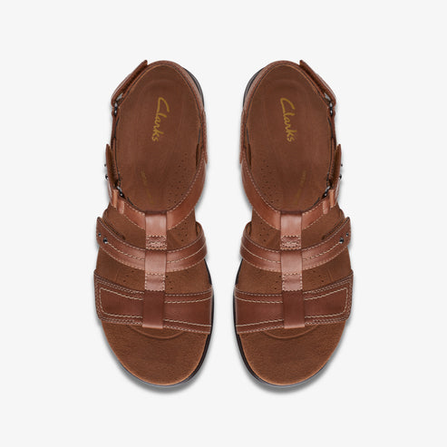 Top view of brown leather sandals with multiple straps and a light brown insole with the word Clarks visible.