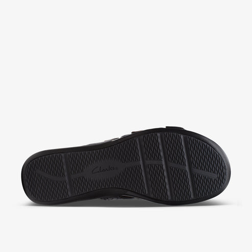 Black shoe sole with tread and "Clarks" imprint.