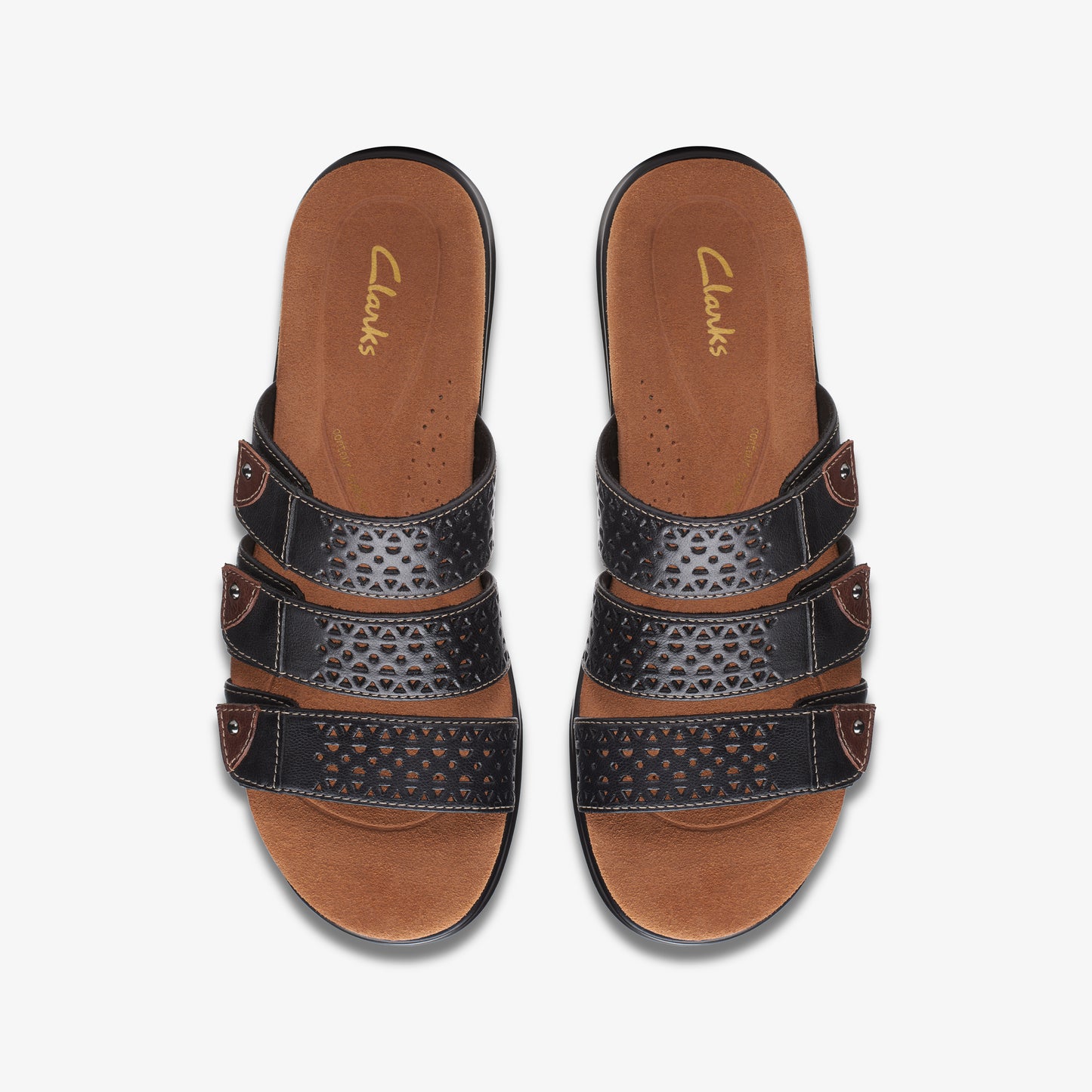 Pair of brown and black slide sandals with three straps; 'Clarks' text on insole.