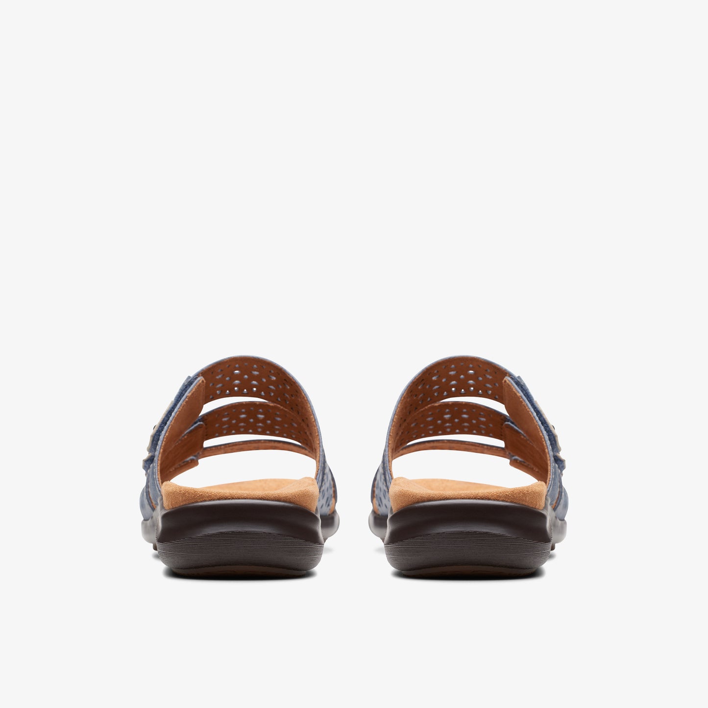 Back view of two blue denim sandals with brown soles and laser cut details.