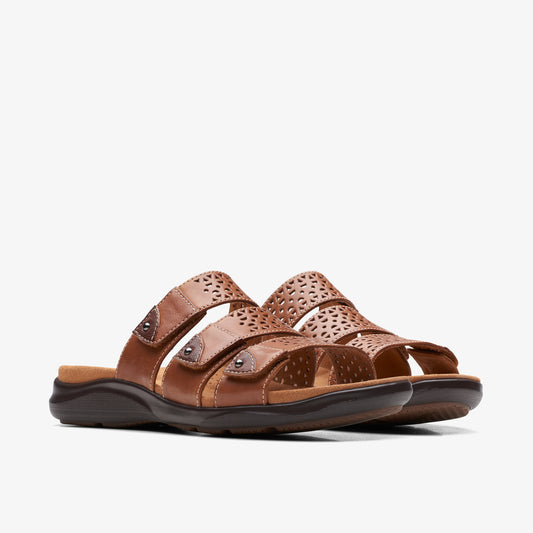 Pair of brown, flat, slip-on sandals with decorative perforation.