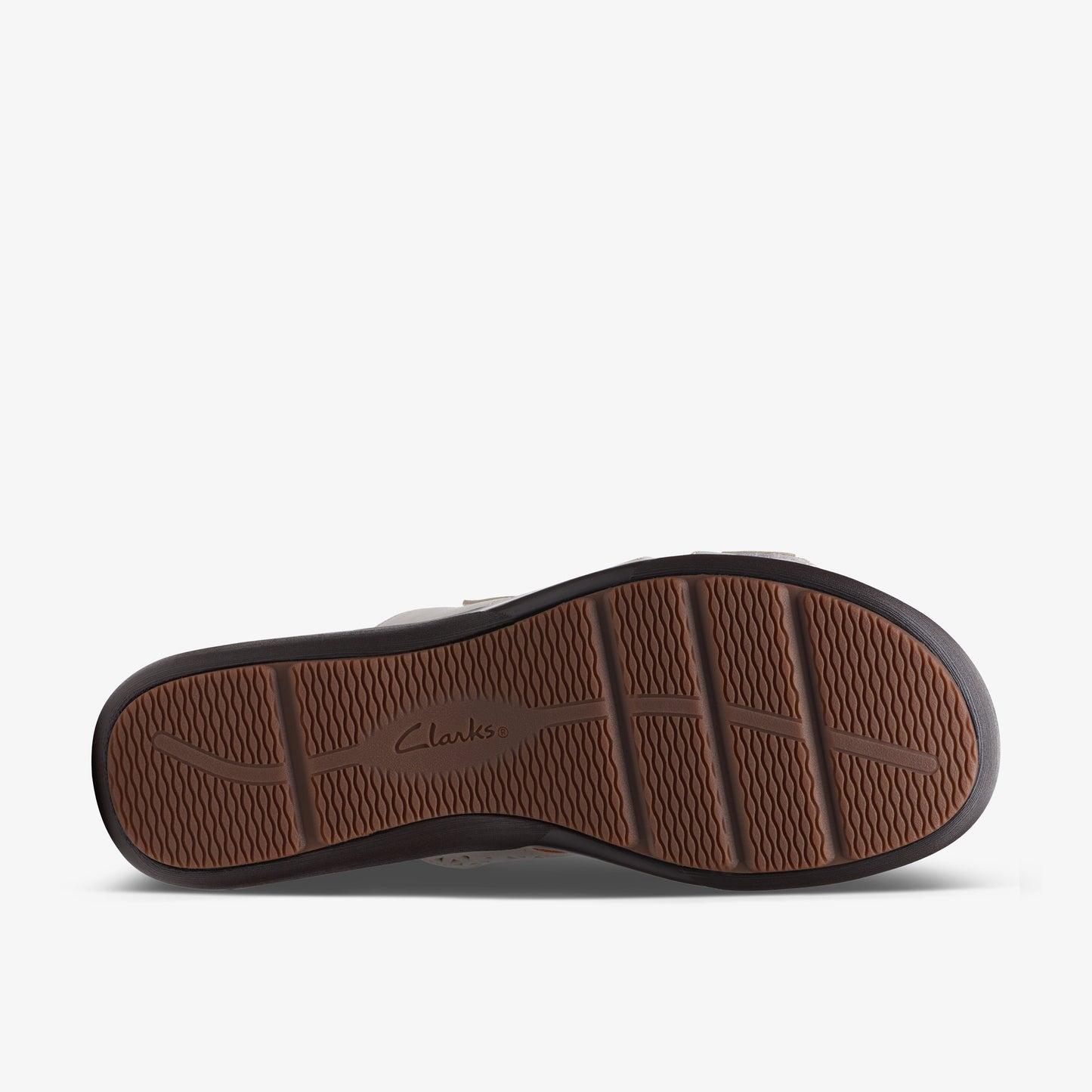 Shoe sole featuring brown tread and the word "Clarks".