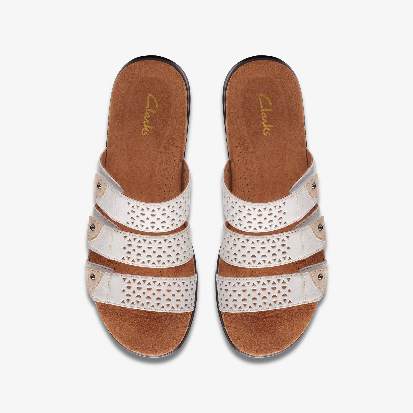 Top-down view of white leather sandals with decorative cutouts and three straps.