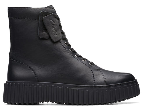 Black leather combat boot with a lug sole and lace-up closure. A label is attached to the laces.