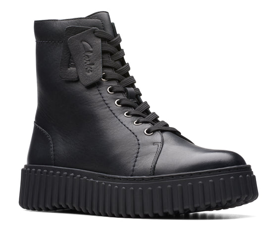 Black leather combat boot with a thick, lugged sole and lace-up closure; a leather logo tag hangs from the laces.