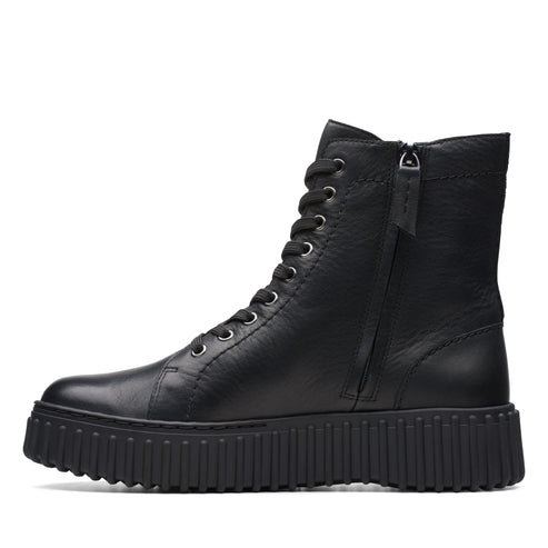 Black, high-top, lug-soled boot with eyelet laces and side zipper.