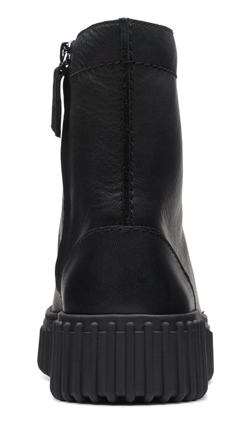 Black leather ankle boot with lug sole and side zipper.