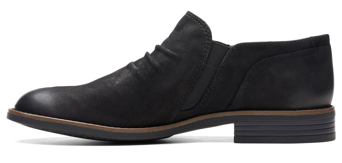 A black leather, low-heel, slip-on shoe.