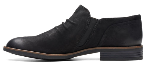 A black leather, low-heel, slip-on shoe.