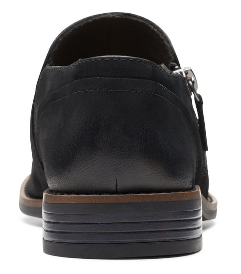 Back view of a black leather loafer with a side zipper.