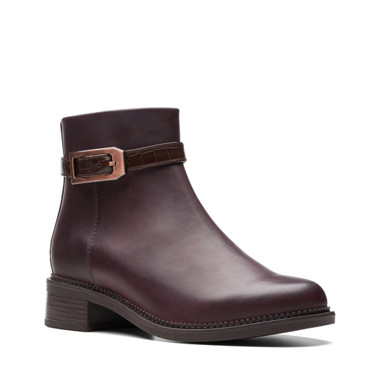 Dark brown leather ankle boot with a decorative buckle strap.