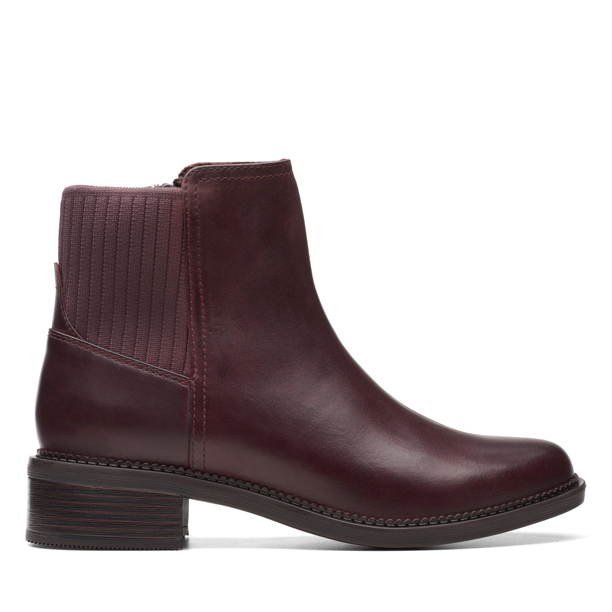 Side view of an ankle-height leather boot with a low block heel and an elasticized ankle.
