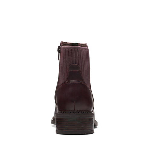 Burgundy ankle boot with ribbed stretch knit upper and zipper closure.