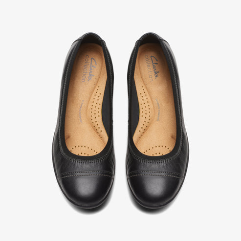 Pair of black leather ballet flat shoes with round toe, cushioned insole.