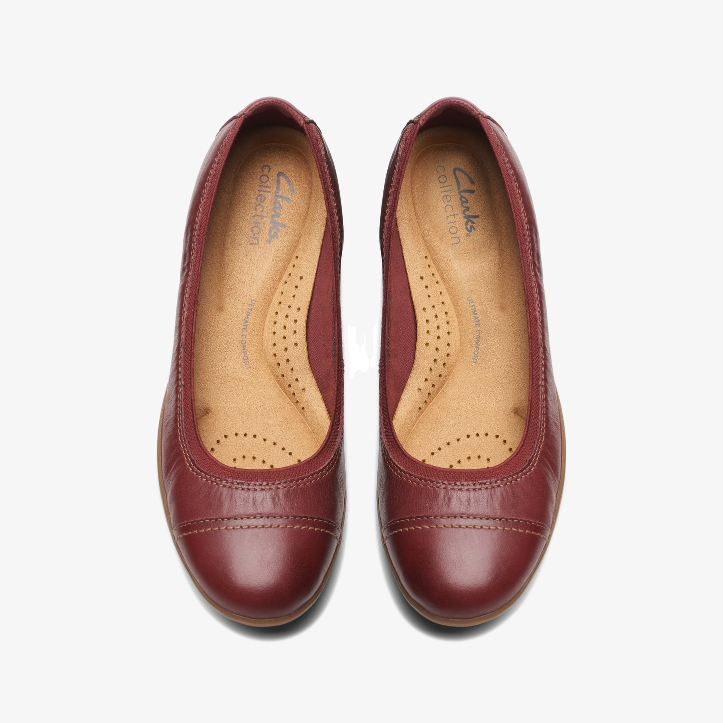 Pair of maroon leather ballet flats with rounded toe.