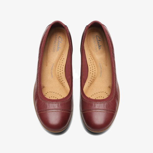 Pair of maroon leather ballet flats with rounded toe.