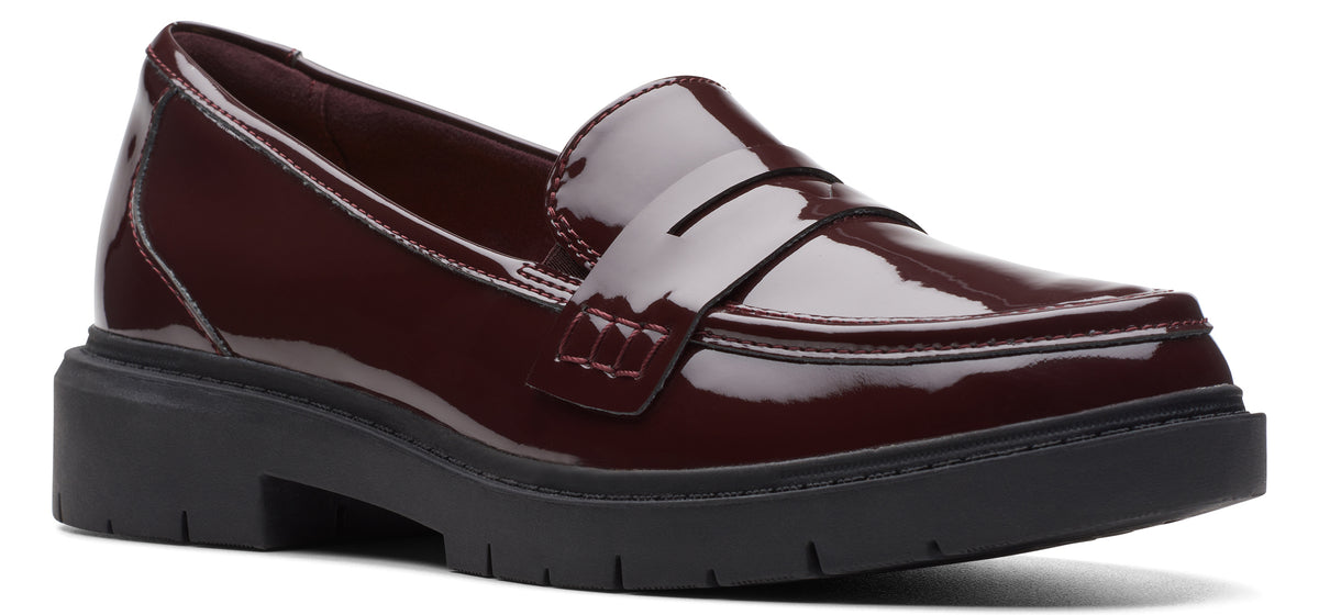 Burgundy patent leather penny loafer with a black lug sole.