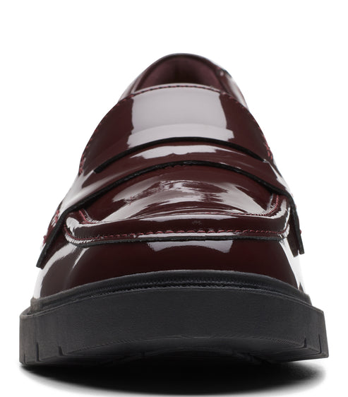 Burgundy patent leather penny loafer with a black sole.