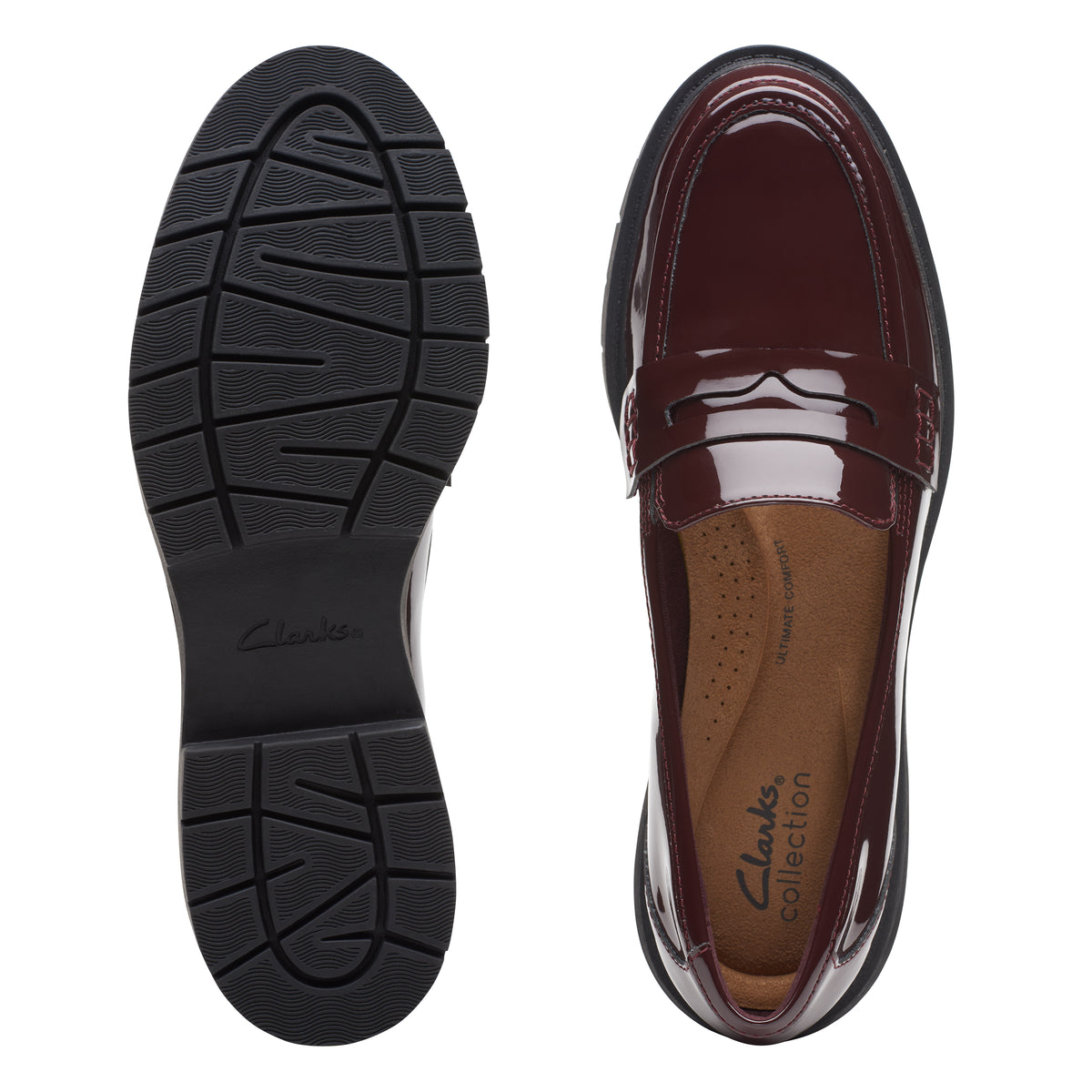 Pair of shoes. Left shoe is sole up. Right shoe is top view, shiny dark red penny loafer.