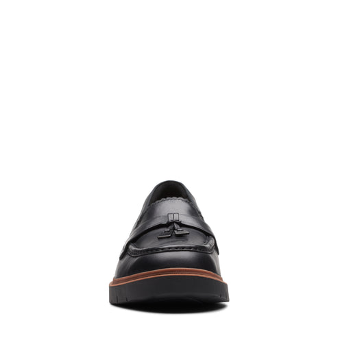 Black leather penny loafer with tassel on upper.