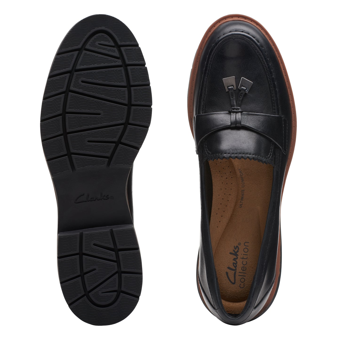 Two black leather tassel loafers with thick black soles and brown trim, one showing the tread.