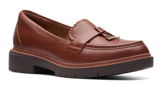Brown leather loafer with tassel and sawtooth accent.
