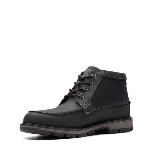 Black leather moccasin toe ankle boot with metal eyelets and treaded sole.
