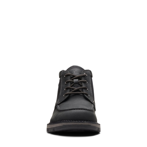 Front view of a black, ankle-high leather boot with laces.