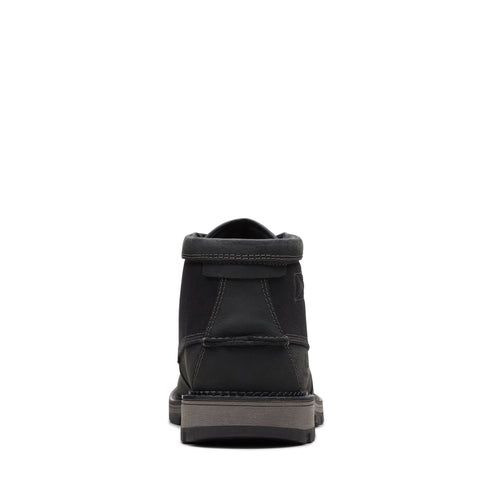 Back view of a black suede ankle-high boot.