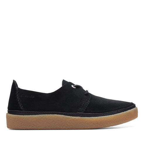 A black suede leather casual shoe with thin black laces and a tan rubber sole.