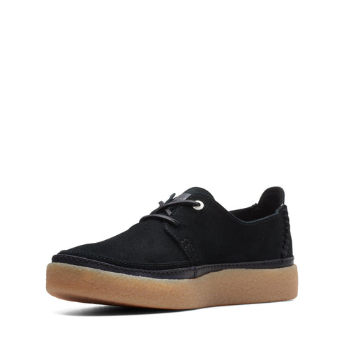 Black, suede, low-profile shoe with brown rubber sole and black laces.