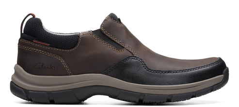 A slip-on shoe featuring a rounded toe, dual elasticated side panels, a cushioned insole, and a durable outsole.