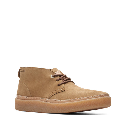 A tan-colored, ankle-high casual boot with brown laces and a matching sole.