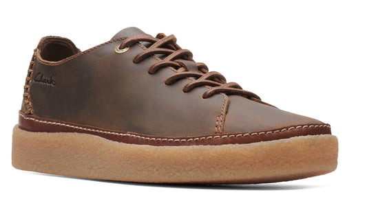 Brown leather lace-up sneaker with a thick, light brown sole.