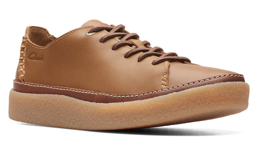 Leather lace-up sneaker with a round toe and a tan-colored platform sole.