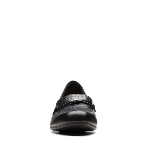 Close-up of a black leather slip-on loafer-style shoe with a faux reptile decorative strap.