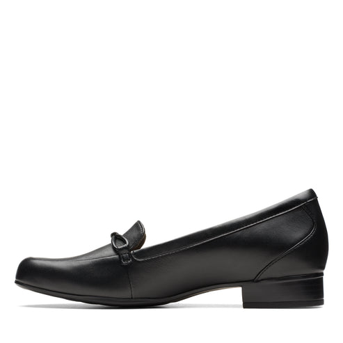 Black leather, low-heeled loafer with a square toe and a decorative strap on the vamp.