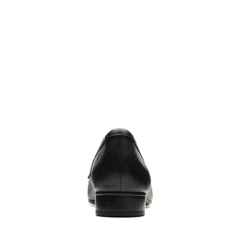 Rear view of a shiny black leather flat shoe with a small heel.