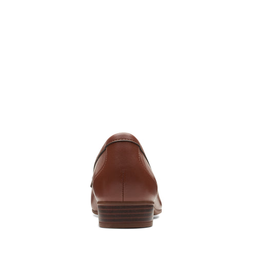 Rear view of a brown leather loafer with a short stacked heel.