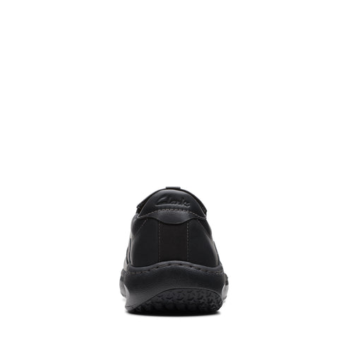 Close-up rear view of a black leather shoe with a black sole and logo on the heel.