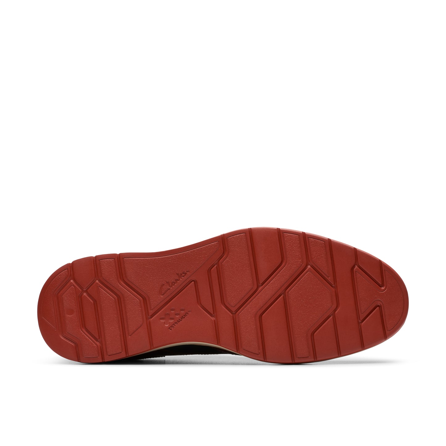 The bottom of a brown shoe with a red sole featuring a geometric pattern.